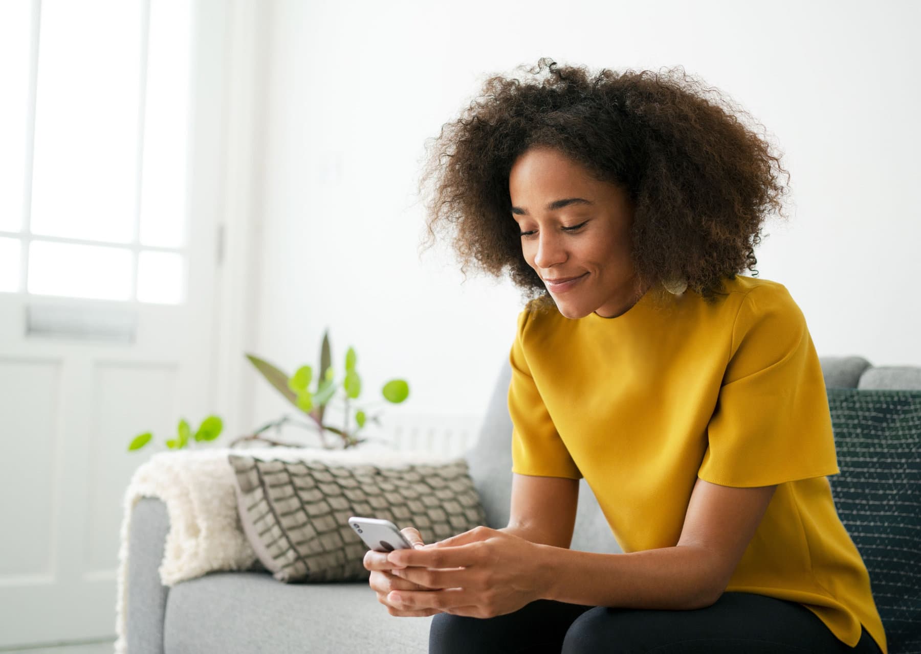 Woman checking her telehealth visit on her phone